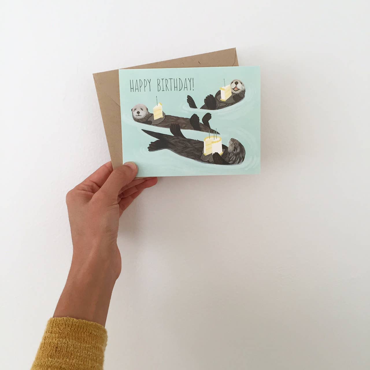 Otters Holding Cake Birthday Card